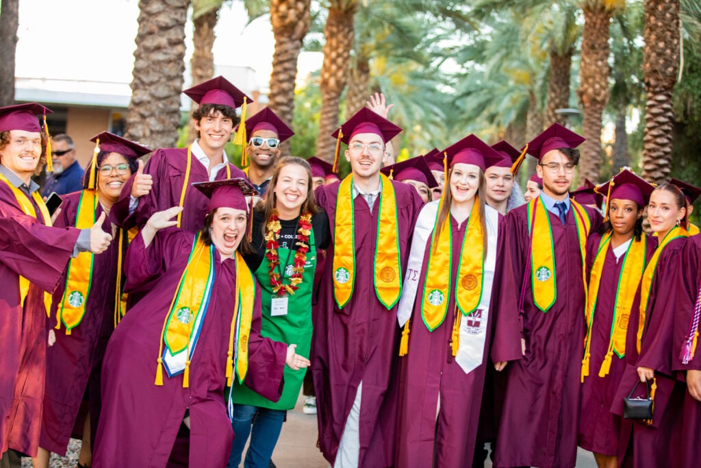Starbucks partners posing after graduation