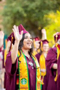 A Starbucks partner graduating from college in her cap and gown