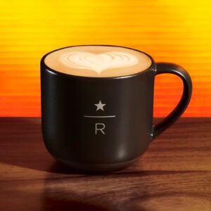 Starbucks reserve dirty chai in black mug on an orange background