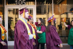 Starbucks partners walking in cup and gowns for ASU graduation