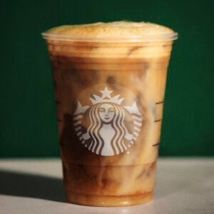 Starbucks Iced Horchata Shaken Oatmilk Espresso on a green background