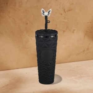 A black, textured tumbler with a geometric design and a butterfly-shaped straw topper. The lid is sleek and features a logo.