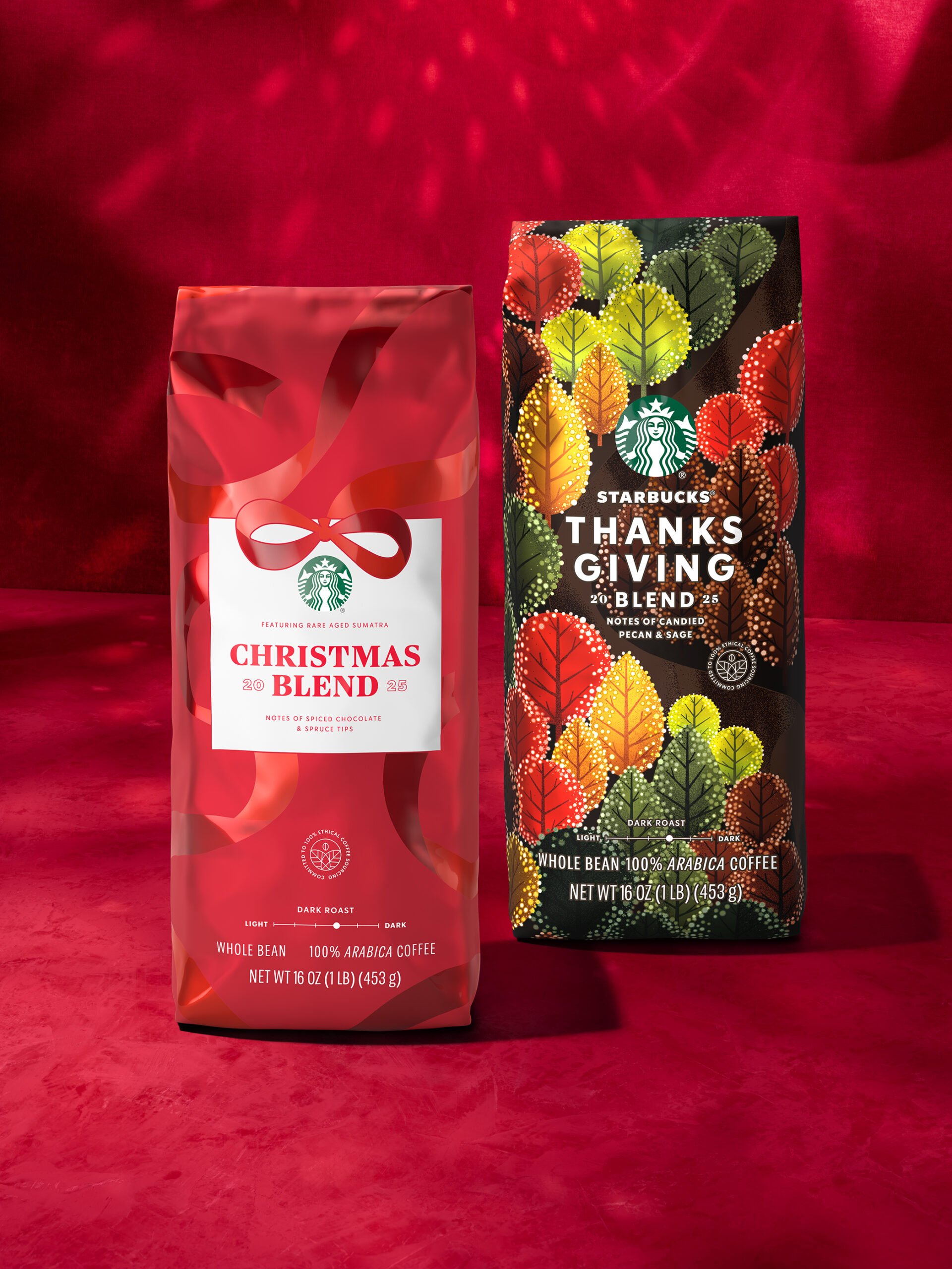 Two bags of coffee are displayed against a red background. On the left is a red bag labeled "Christmas Blend," featuring a bow design, and notes of spiced chocolate. On the right, a colorful bag labeled "Thanksgiving Blend" showcases autumn leaves and notes of candied pecan. Both bags are 16 oz. of whole bean coffee.
