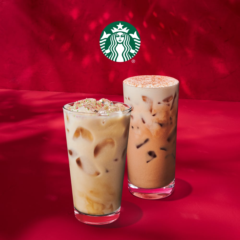Two iced beverages are displayed against a red background. The left drink is creamy with a festive topping, while the right drink is darker with a frothy surface.