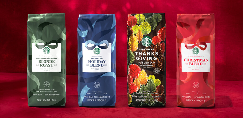 Four bags of Starbucks coffee are displayed against a red background. They include: 1. **Christmas Blonde Roast** - Green bag with notes of spiced orange and fig compote. 2. **Holiday Blend** - Blue bag featuring sweet maple and herbs. 3. **Thanksgiving Blend** - Dark bag with colorful leaf designs, notes of candied pecan and sage. 4. **Christmas Blend** - Red bag with notes of spiced chocolate and spruce tips. Each bag is labeled with its weight and coffee type.