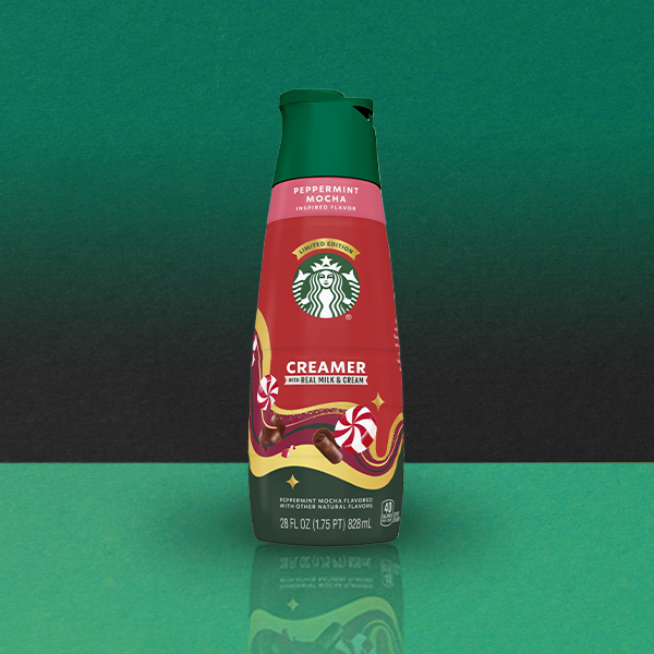 A bottle of Starbucks Peppermint Mocha creamer, featuring a red design with peppermint and chocolate graphics. It holds 28 fl oz.