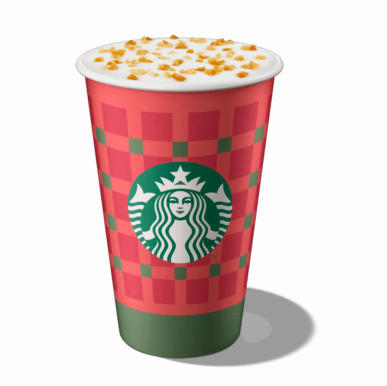 A festive red and green checkered cup with a white lid, topped with whipped cream and caramel bits, featuring the Starbucks logo.