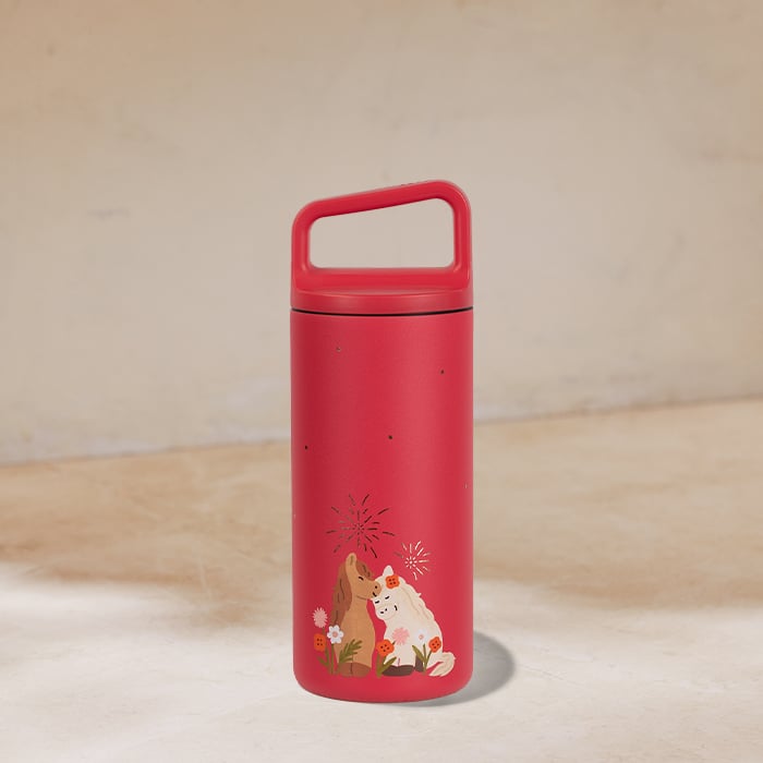A vibrant red insulated bottle features a playful design with two animals surrounded by flowers and decorative elements.