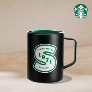 A black Starbucks mug features a green logo with "THE STARBUCKS 1971 COFFEE CO." and a stylized "S." The mug has a handle and a lid.