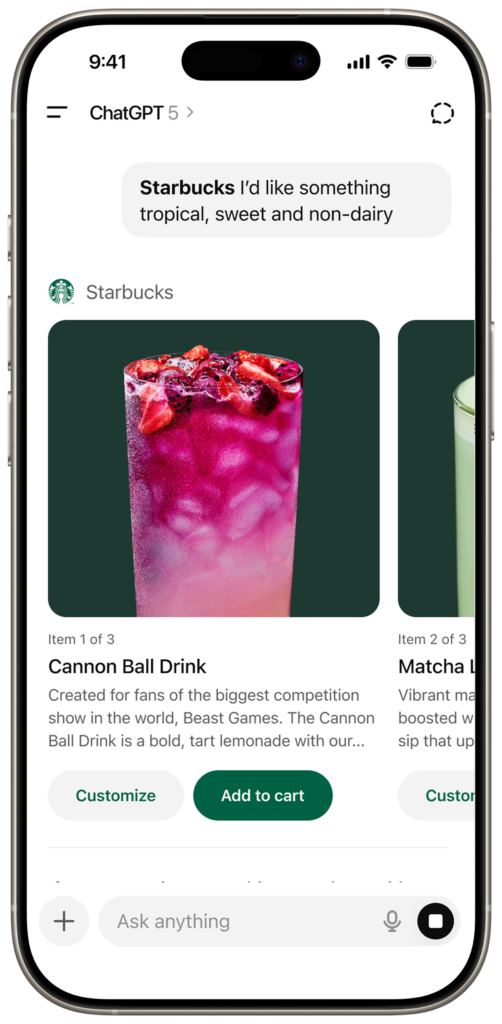A vibrant pink drink filled with ice and topped with strawberries and blackberries, served in a clear glass.