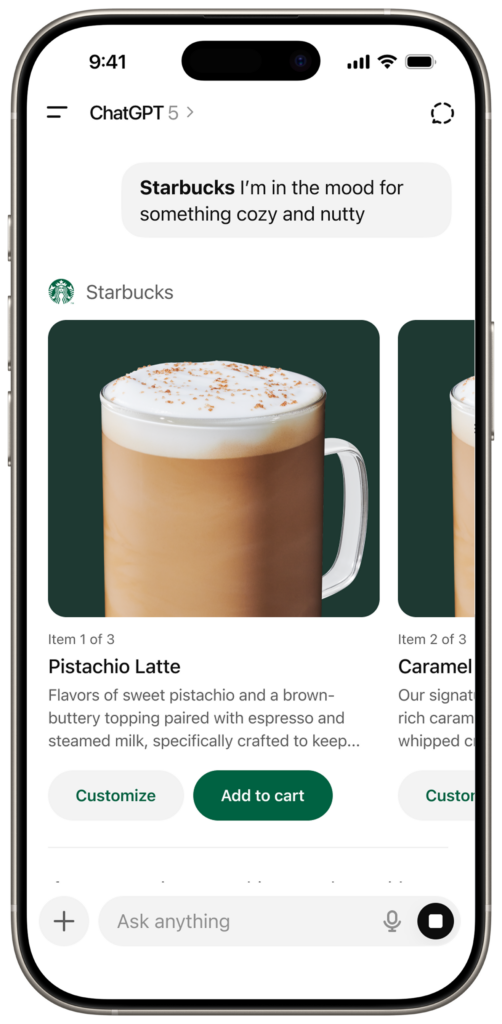 A glass mug filled with a creamy pistachio latte topped with frothy milk and a sprinkle of cinnamon. The background is dark green.