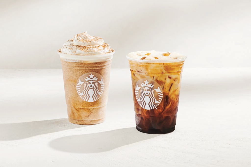Two Starbucks beverages are displayed: a blended drink topped with whipped cream and cinnamon, and an iced coffee with visible ice cubes. Both cups feature the Starbucks logo.