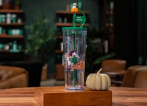 A clear cup with Linus jumping into leaves