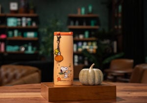 An orange tumbler with Snoopy